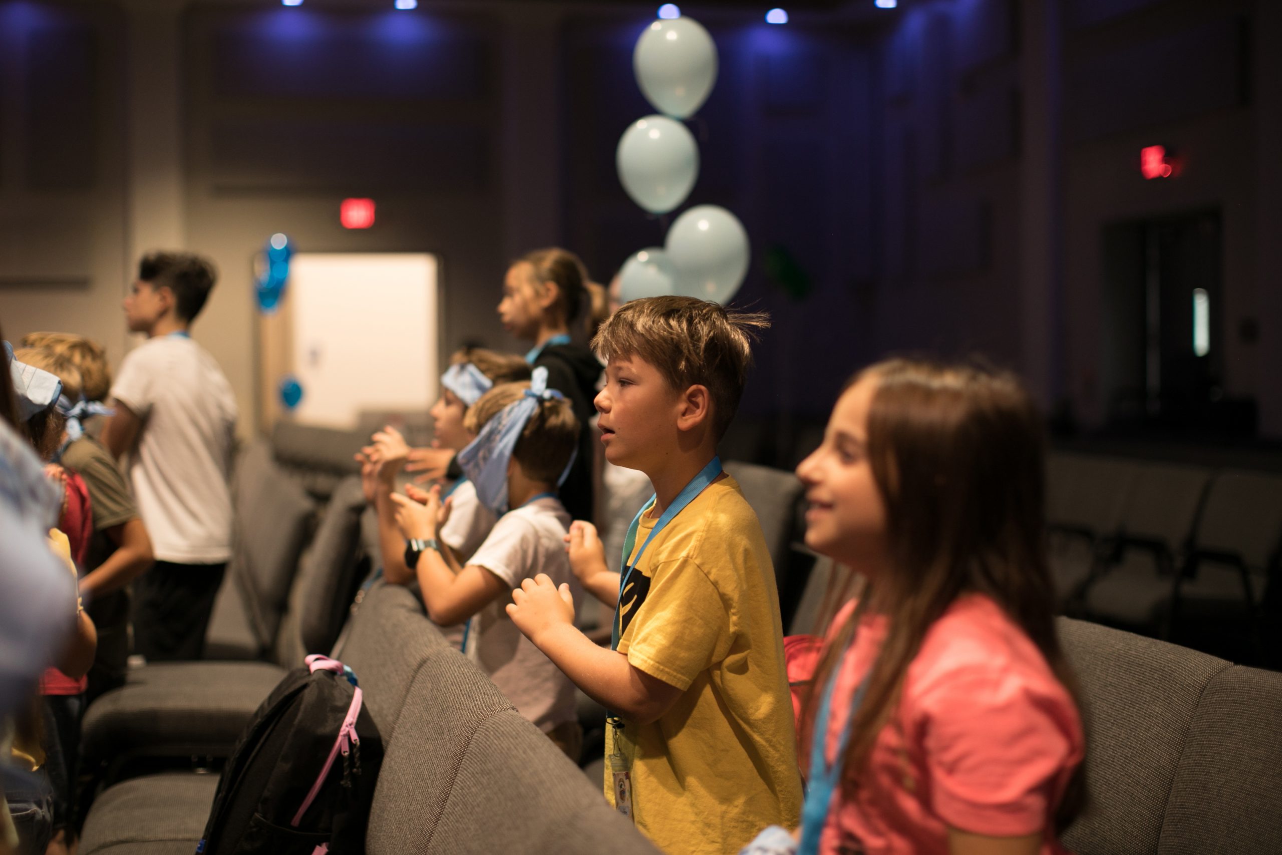 Group of little kids playing games, dancing in circle and having